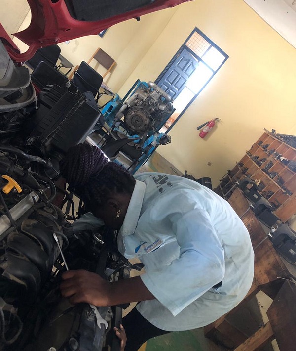 Priscilla working on a client's car